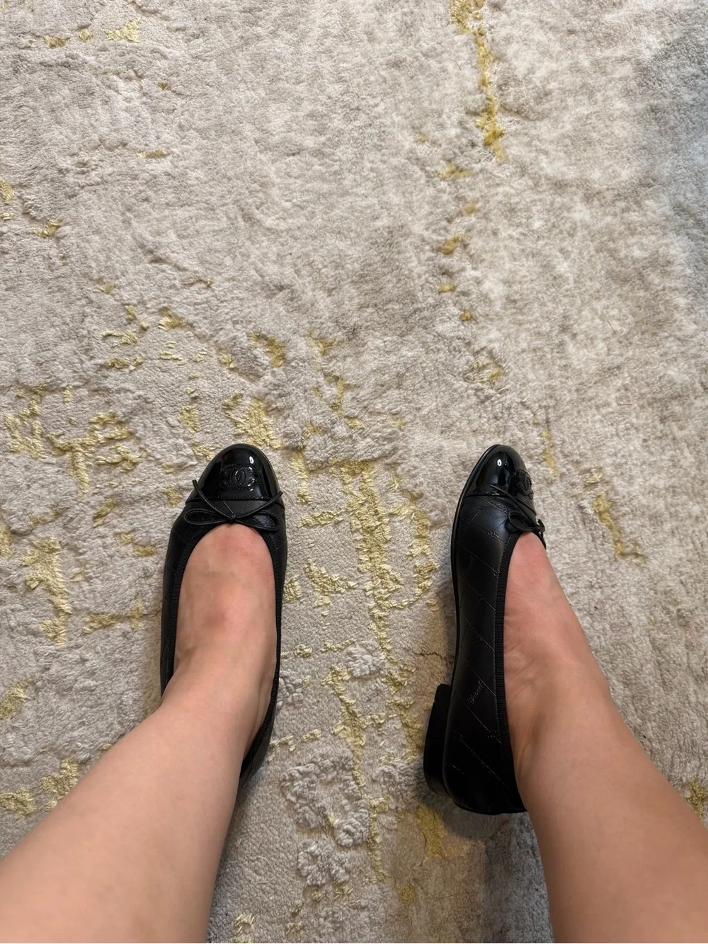 CHANEL Black Quilted Leather Cap-Toe Bow Ballet Flats